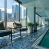 Indoor pool with lounging areas and stunning skyline views at State and Grand Chicago apartment rentals